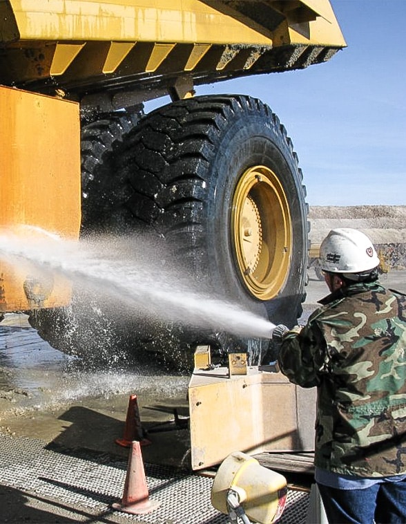 Heavy-duty mining vehicle being manually washed