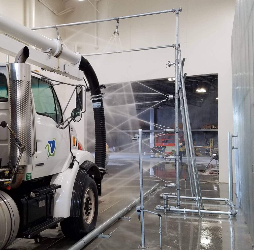 Truck going through automatic wash system.