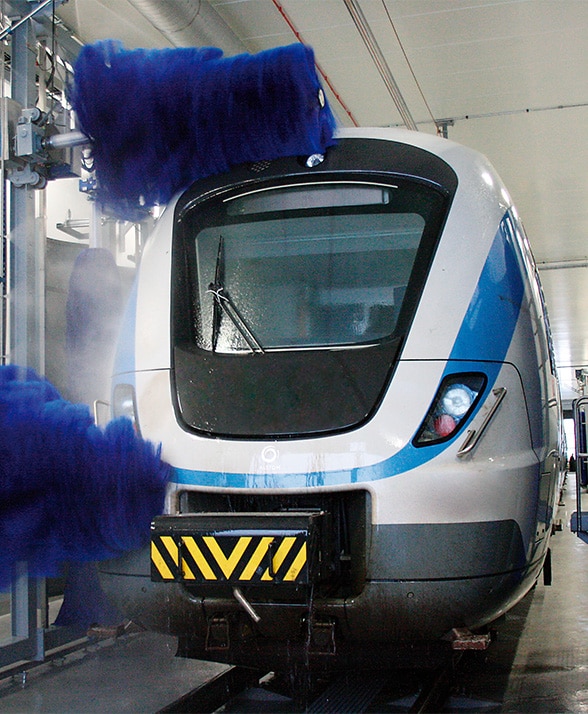Railway system being washed with a brush.