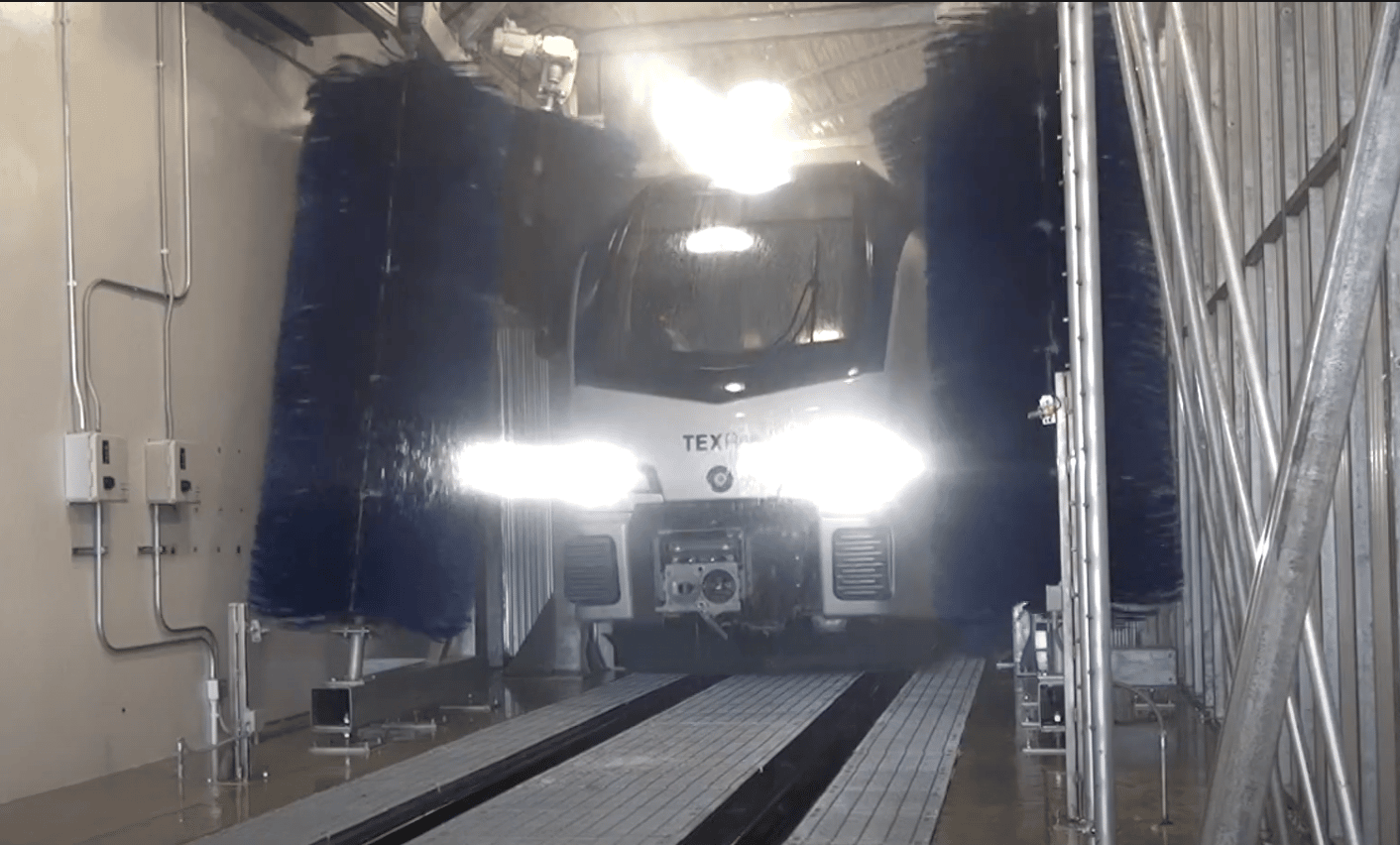 LRT train driving through wash system