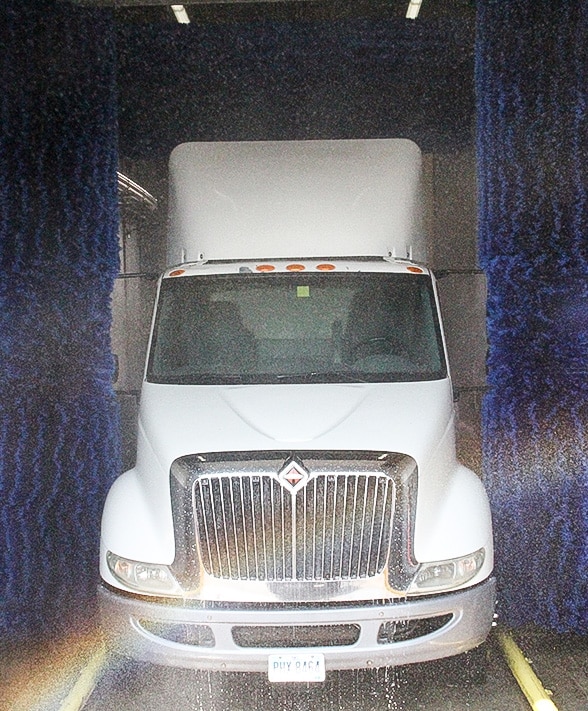 Heavy duty detergents being applied to semi inside drive-through wash system