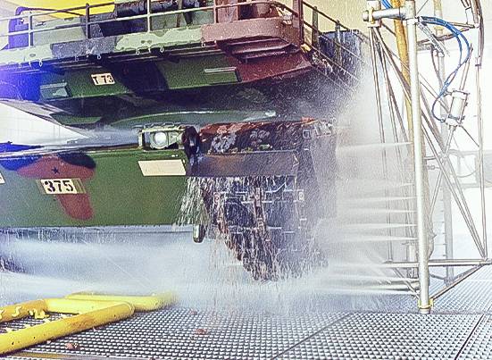 Military tank tracks being washed