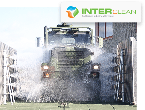 Military truck going through wheel and chassis wash system