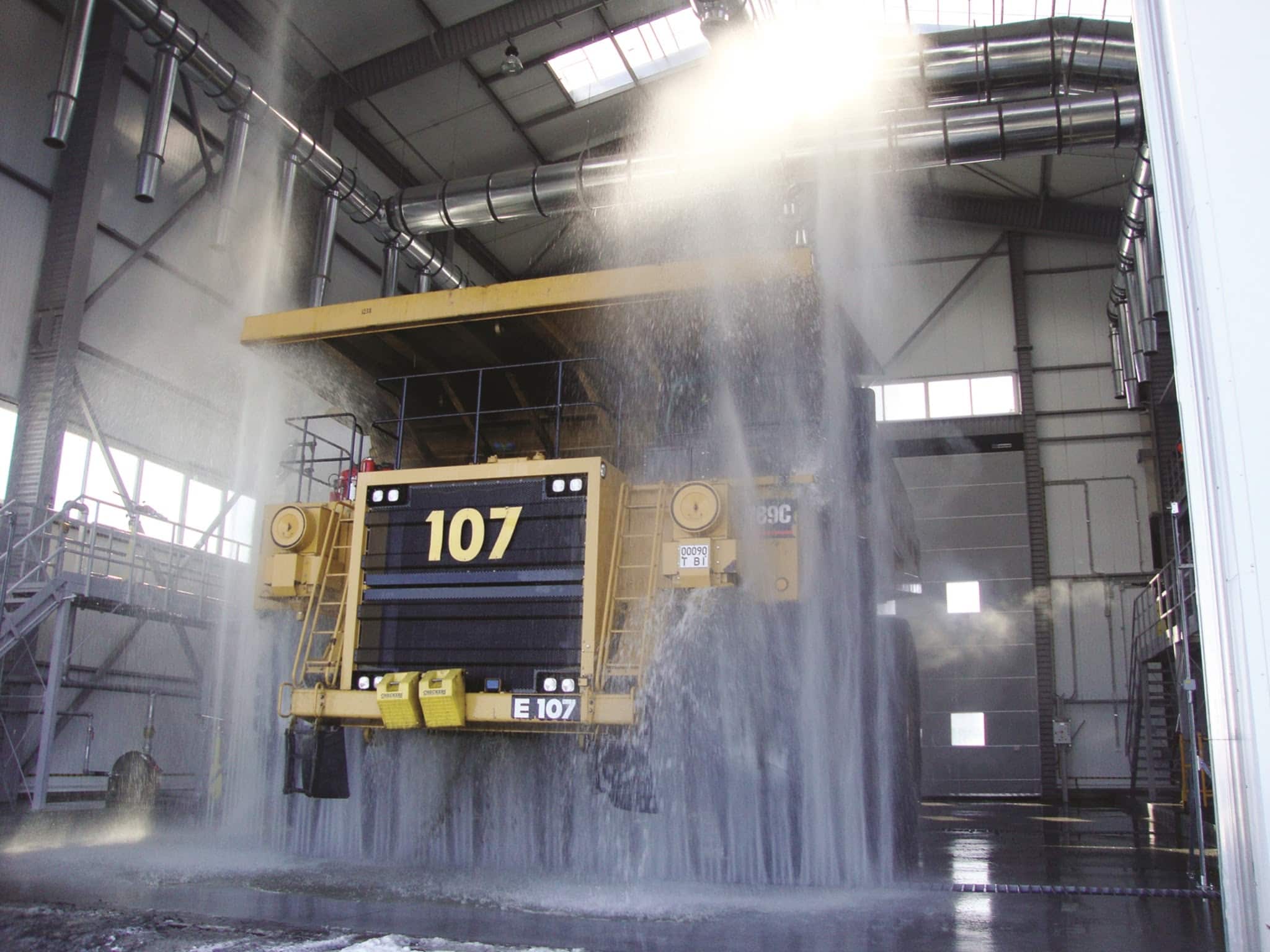 Mining vehicle inside drive-through wash system