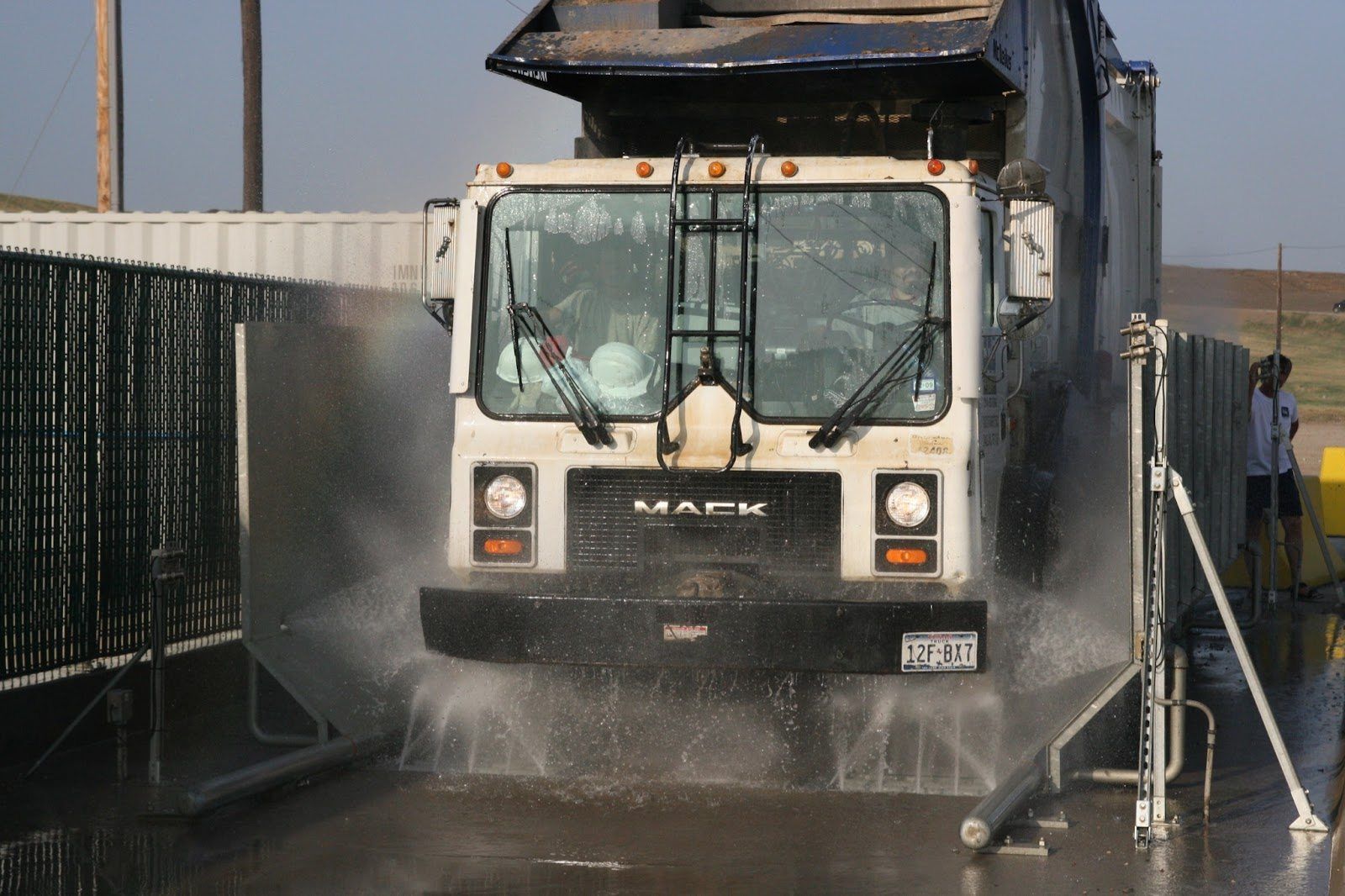 Municipal dump truck wheels and chassis being washed