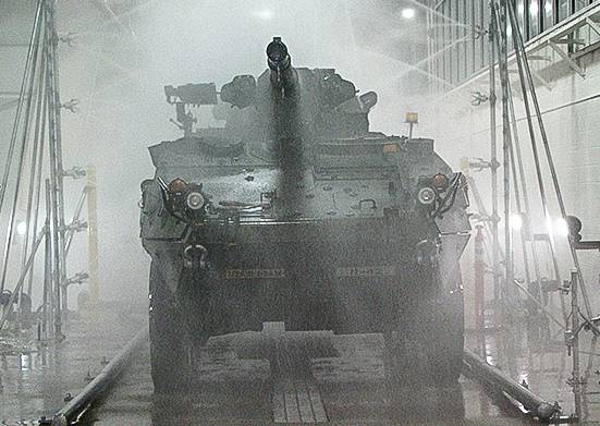 Smaller military tank going through touchless wash system