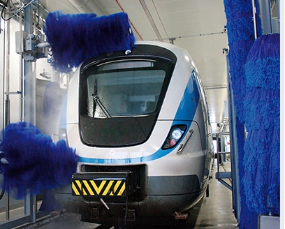 Train being washed by blue brush system