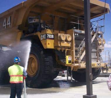 A heavy-duty truck being washed by an InterClean system.