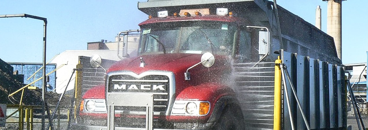 A heavy-duty truck being washed by an InterClean wash system.