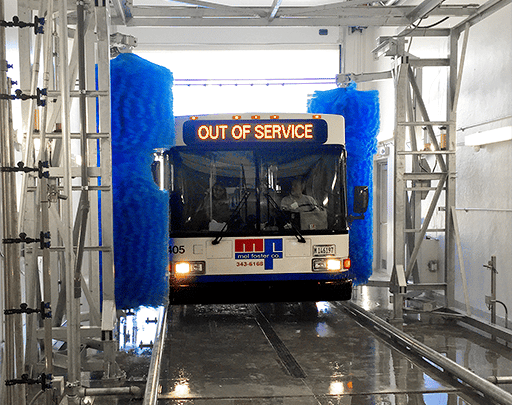 A double-decker bus going through an InterClean transit wash system.