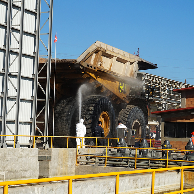High-pressure wash monitors are used by wash system operators to detail clean the rear and under body of Haul Truck 641, Buenavista del Cobre Mine Site
