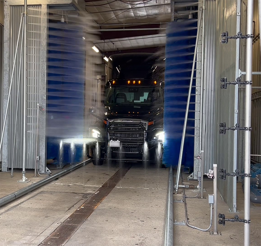 Automatic Friction Wash System Cleaning a semi truck